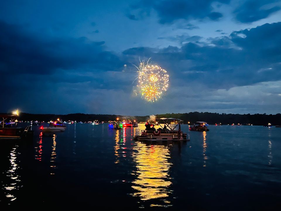 Fourth of July fireworks over Jackson Lake, with boats gathered on the water