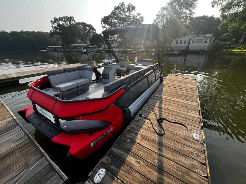 Red Sea-Doo Switch tritoon tied up alongside a wooden dock