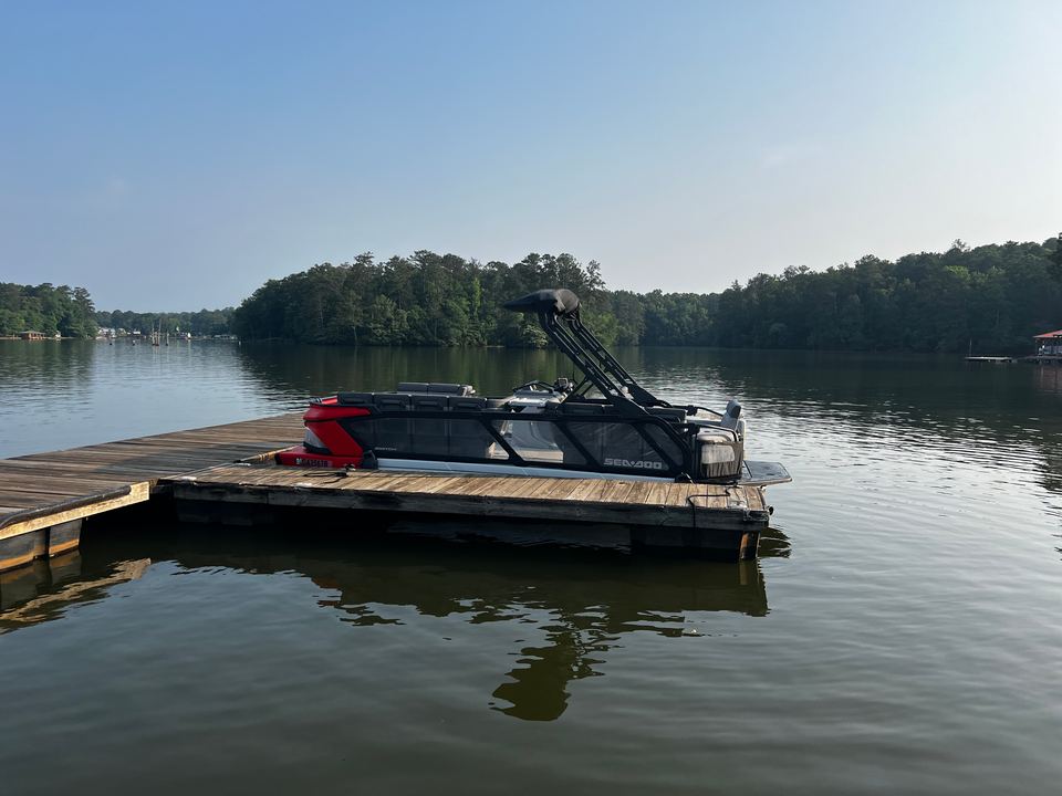 Red Sea-Doo Switch tied up at a floating dock on Jackson Lake in evening light