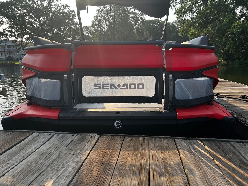 Stern of the red Sea-Doo Switch with the Sea-Doo logo, at the dock