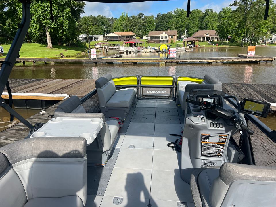 Open deck and gray seating on the yellow Sea-Doo Switch, docked on the lake