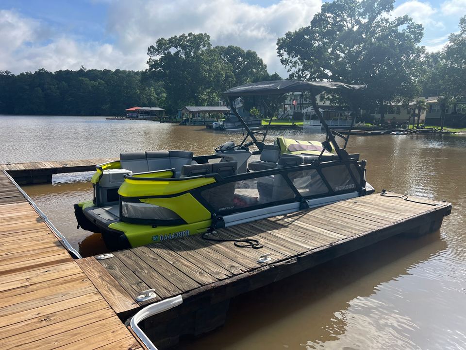 Yellow Sea-Doo Switch tied up at the end of a wooden dock