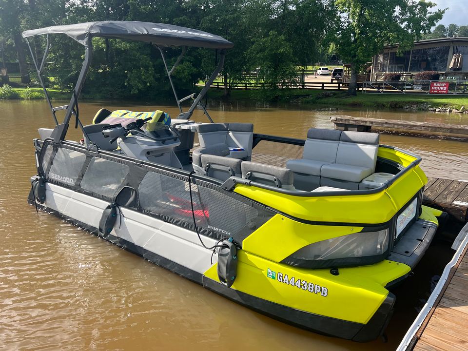 Side view of the yellow Sea-Doo Switch tritoon at the dock